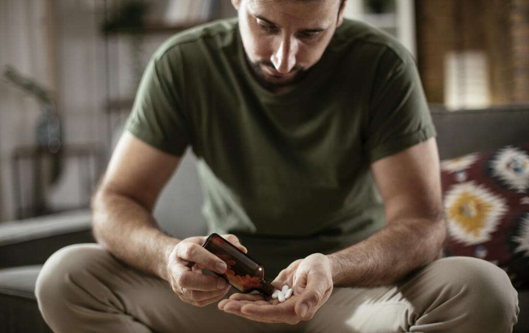 Man holding pills