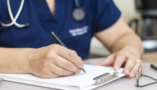 Getty Images-1364802754-healthcare-worker-writing-on-form