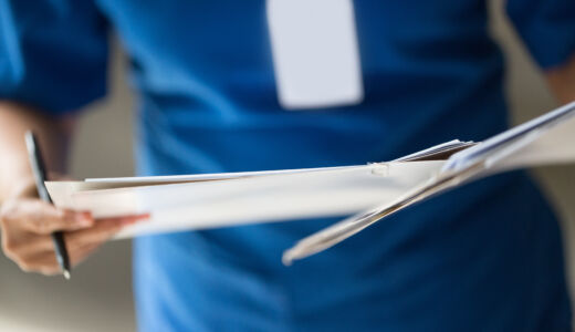 Getty Images-529315953-nurse-checking-patient-document