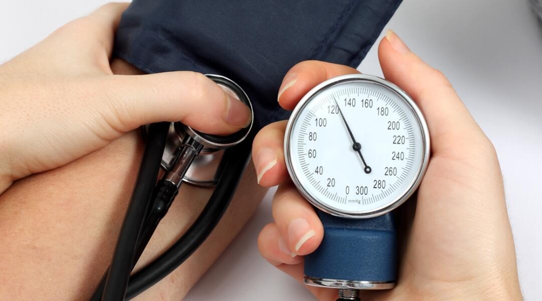 Doctor taking blood pressure reading close up