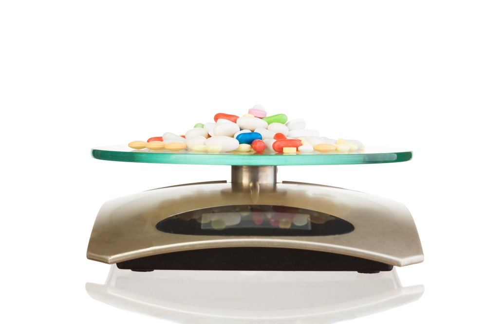 Pile of medicines on a scale, being weighed