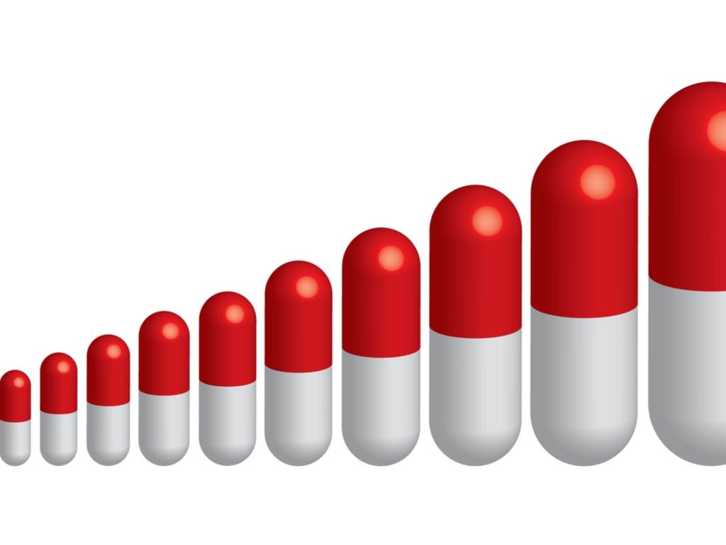 red and white capsules increasing from small to large left to right. 