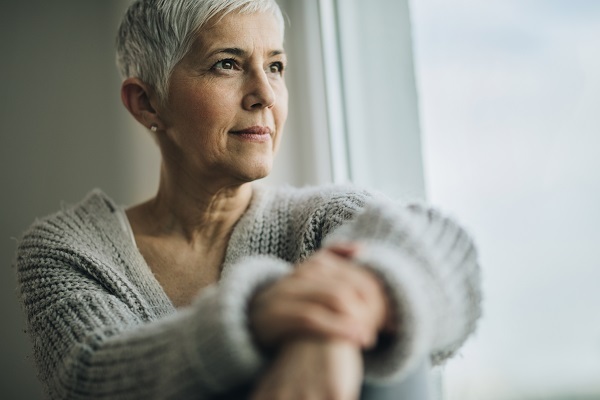 Woman looking out window into distance