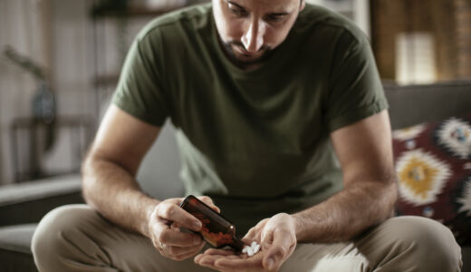 Man holding pills