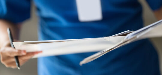 Getty Images-529315953-nurse-checking-patient-document