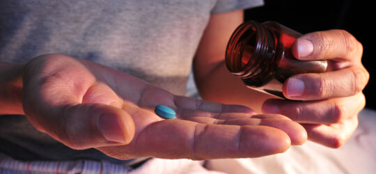 Blue pill in hand