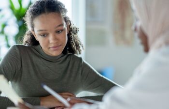 Getty Images-1350731630-young-person-with-doctor-cropped